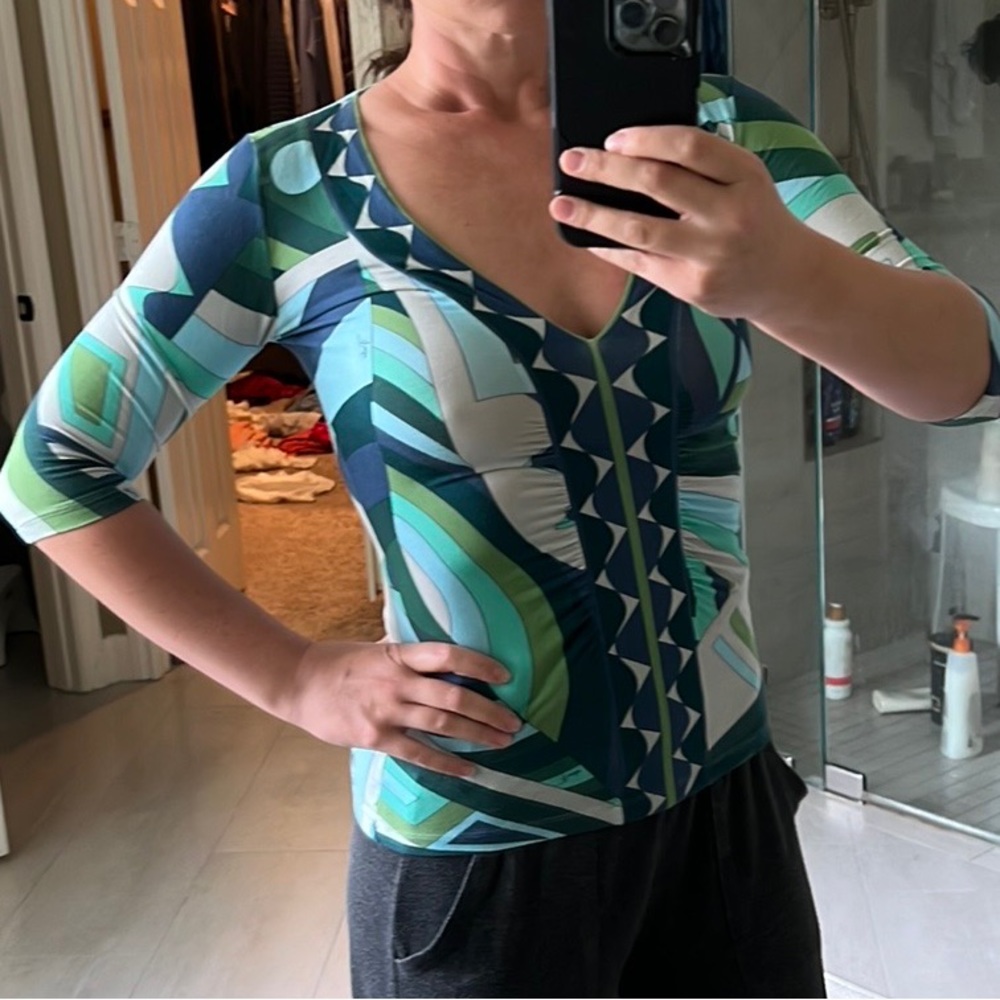 Runs small. Tight fit but flattering